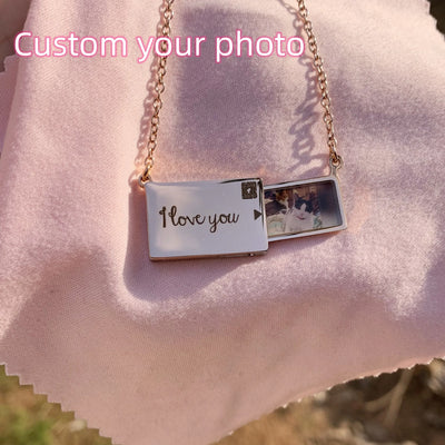 Customizable stainless steel pendant necklace with photo insert and "I Love You" message on pink fabric background.